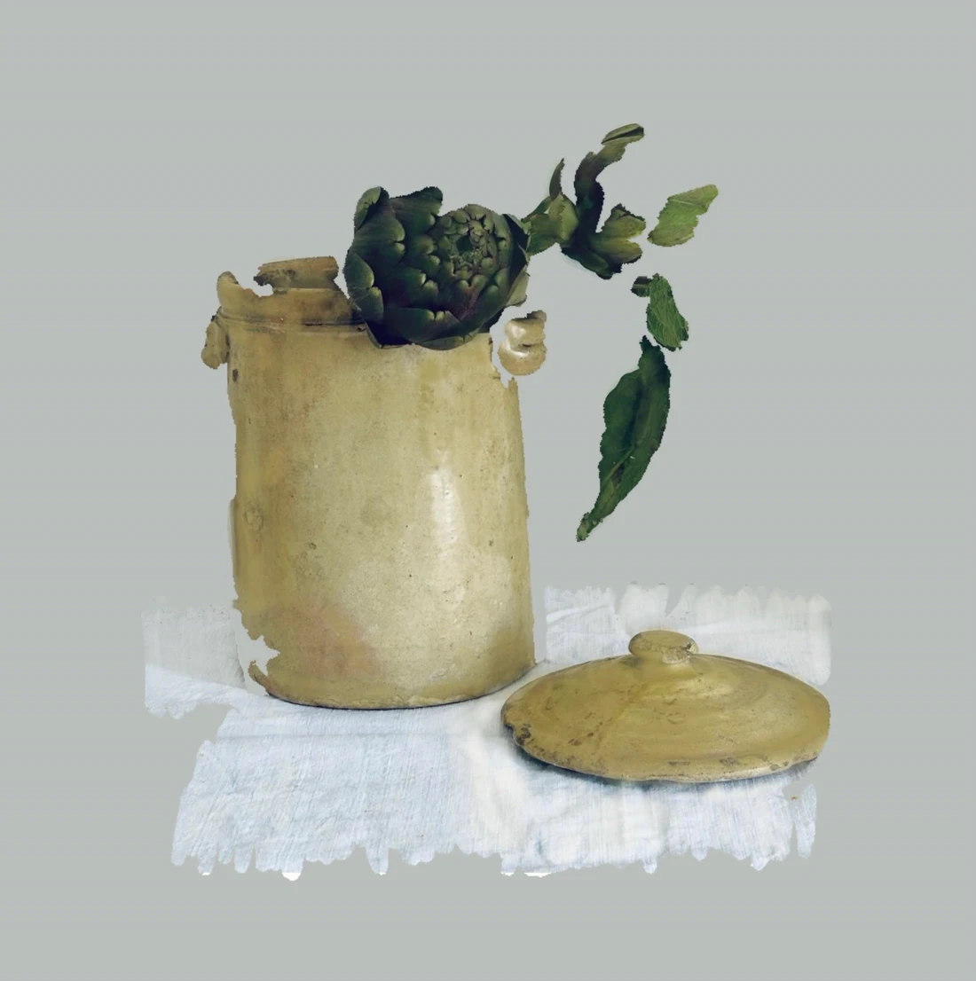 An old preserving jar, an artichoke and a folded cloth, partly erased so that sections of the objects fall away into bare ground.